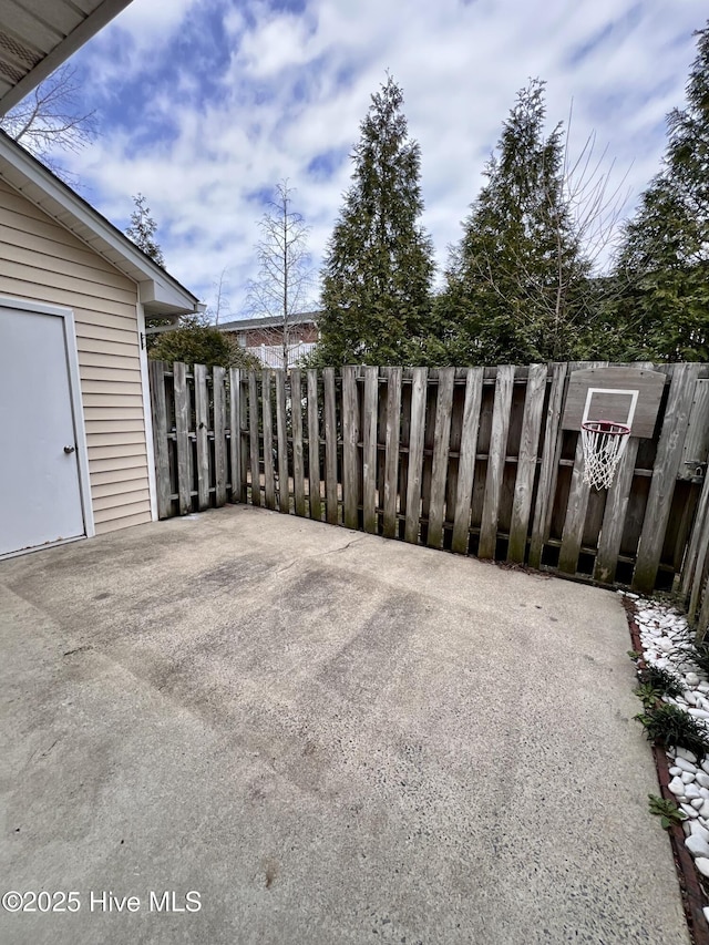 view of patio featuring fence