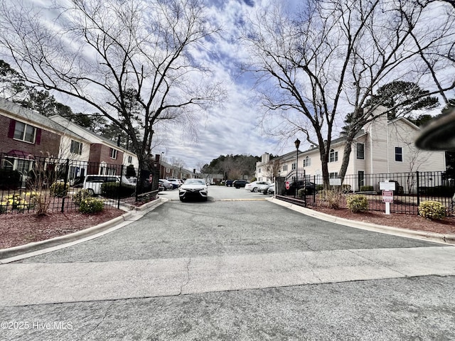 view of street featuring a residential view and curbs