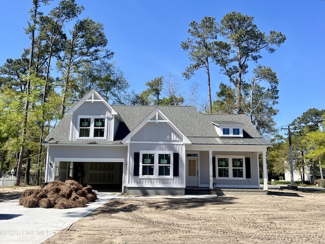 view of front of property with an attached garage, driveway, and roof with shingles