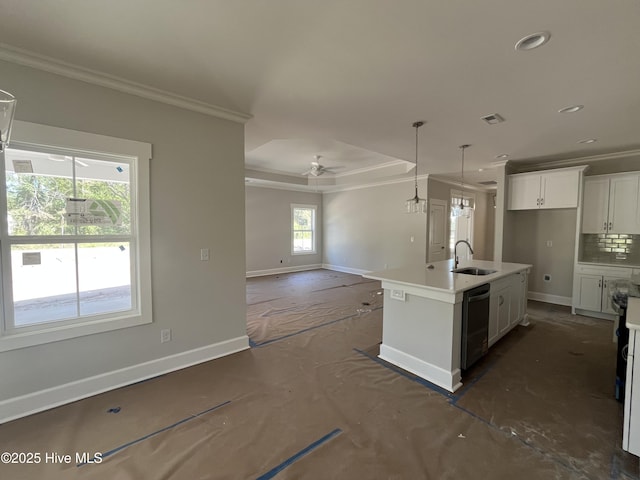 kitchen featuring crown molding, baseboards, dishwasher, and a sink