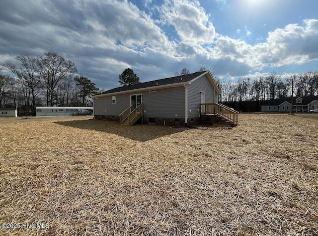 rear view of house featuring crawl space