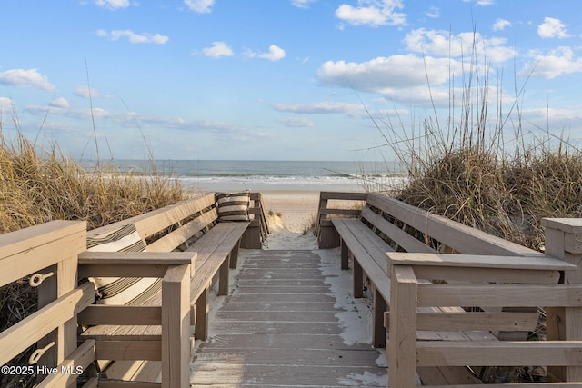 surrounding community featuring a view of the beach and a water view