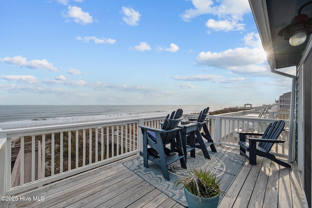 deck featuring a beach view and a water view