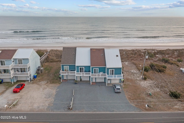 aerial view with a water view and a view of the beach