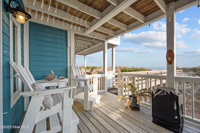 wooden deck with a grill