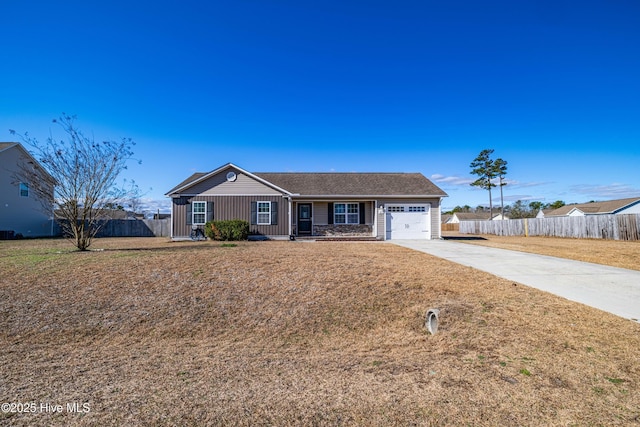 single story home featuring concrete driveway, an attached garage, fence, and board and batten siding