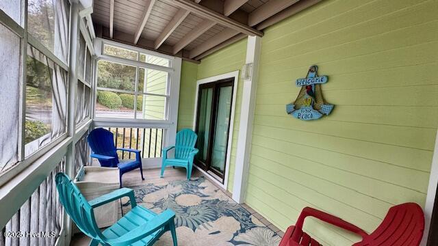 sunroom / solarium with beamed ceiling