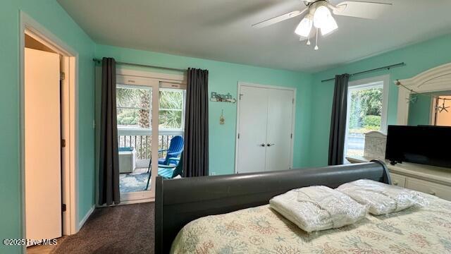 bedroom with dark colored carpet, multiple windows, ceiling fan, and access to outside