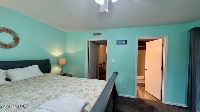 bedroom with visible vents, baseboards, a ceiling fan, and dark carpet