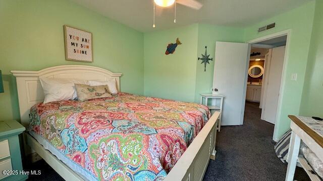 bedroom with dark colored carpet, visible vents, and a ceiling fan