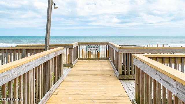 surrounding community featuring a view of the beach and a water view