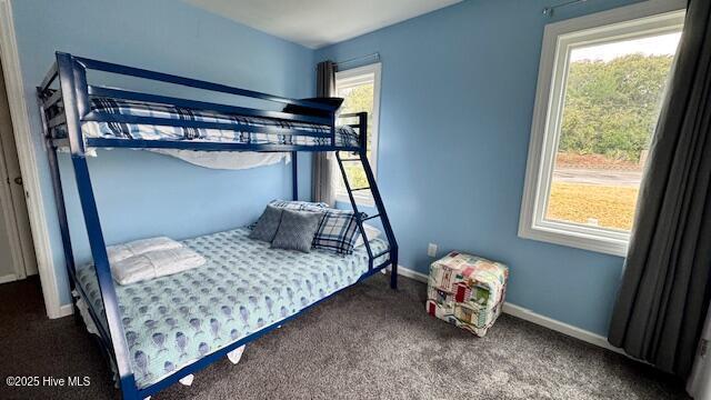 carpeted bedroom featuring baseboards