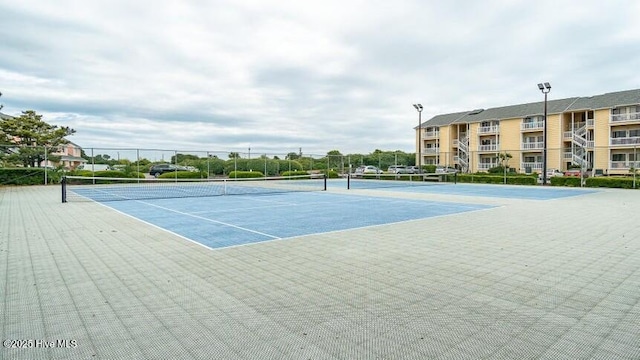 view of sport court featuring fence