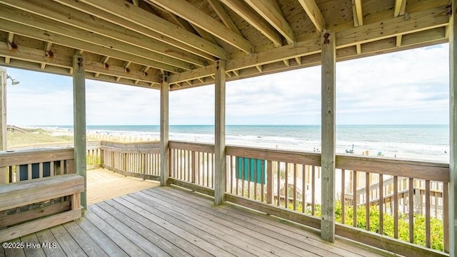 wooden terrace with a beach view and a water view