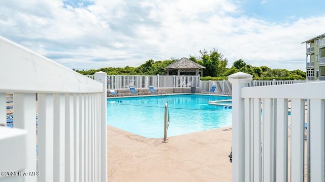 community pool featuring a gazebo and fence