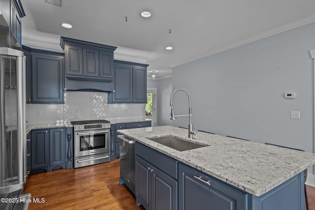 kitchen with premium range hood, a sink, blue cabinetry, appliances with stainless steel finishes, and crown molding