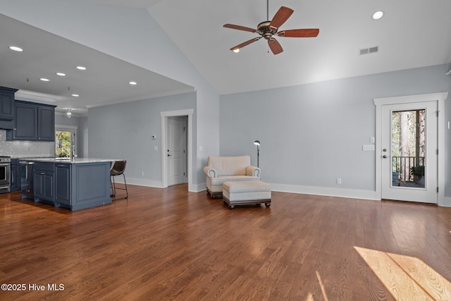 interior space featuring dark wood-style floors, baseboards, visible vents, ornamental molding, and ceiling fan