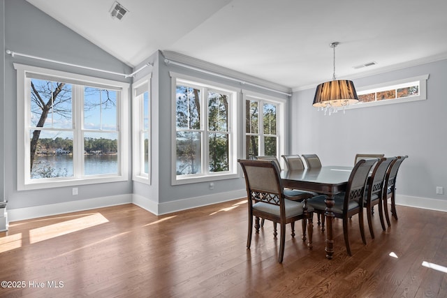 dining room with visible vents, baseboards, ornamental molding, and dark wood-style flooring