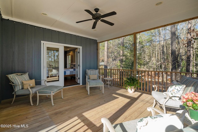 sunroom / solarium featuring ceiling fan