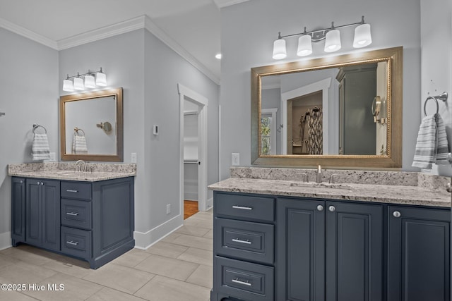 bathroom with two vanities, crown molding, baseboards, and a sink