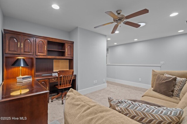 office space featuring recessed lighting, a ceiling fan, light colored carpet, and baseboards