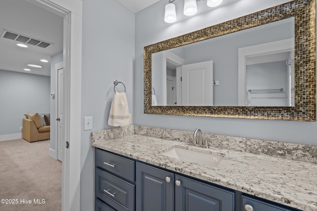 bathroom with recessed lighting, visible vents, baseboards, and vanity