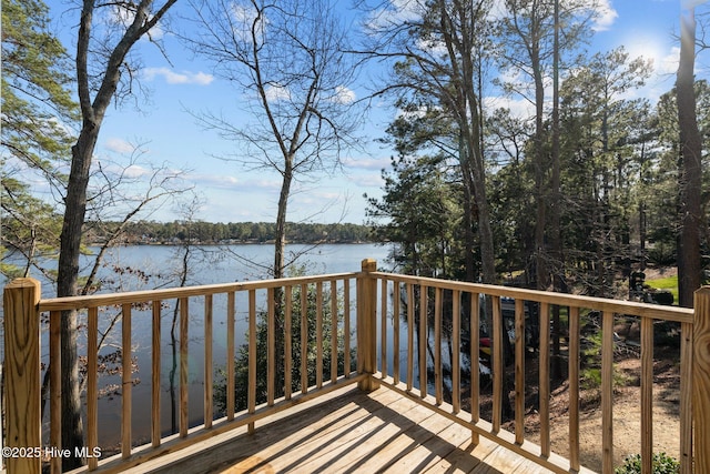 wooden terrace featuring a water view