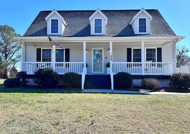 cape cod-style house featuring a porch, a front yard, and a shingled roof