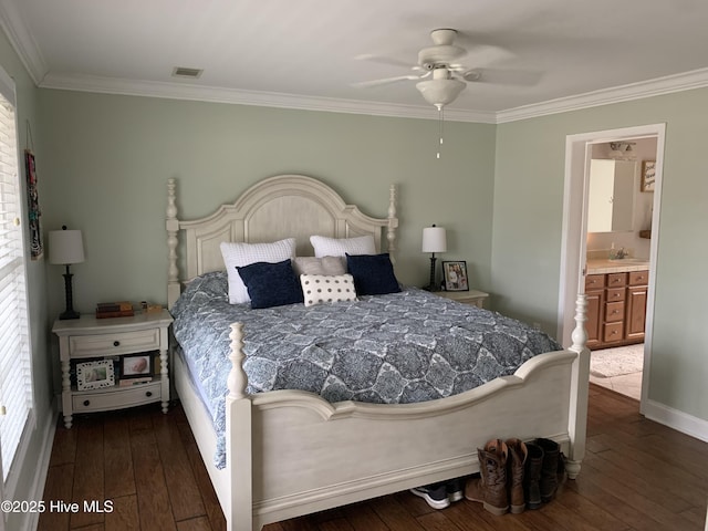 bedroom featuring a sink, ornamental molding, dark wood finished floors, and ensuite bathroom