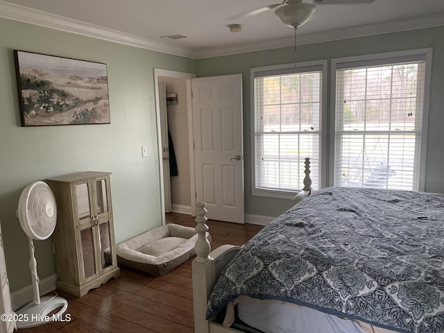 bedroom with ceiling fan, visible vents, baseboards, ornamental molding, and dark wood finished floors