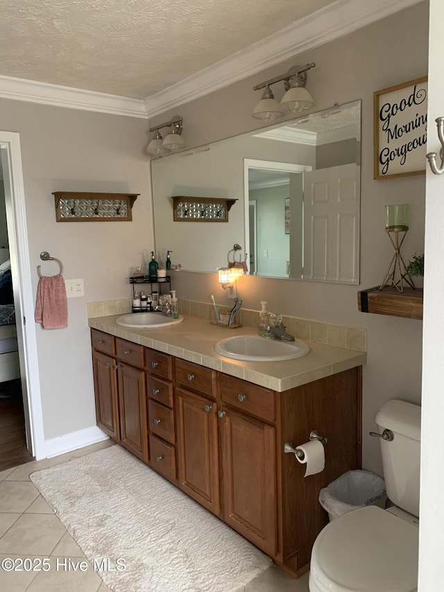 full bath with ornamental molding, a sink, and toilet