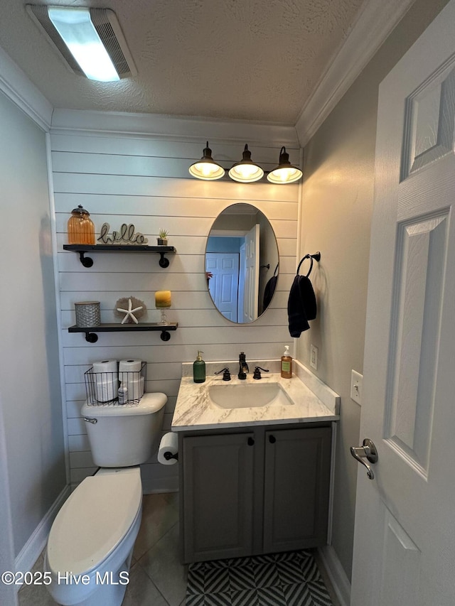 bathroom featuring visible vents, toilet, ornamental molding, a textured ceiling, and vanity