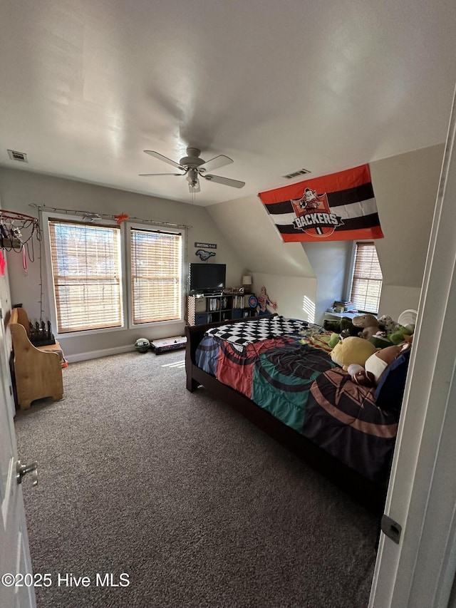 carpeted bedroom featuring lofted ceiling, visible vents, and ceiling fan