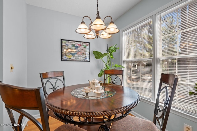 dining area with an inviting chandelier, wood finished floors, and baseboards