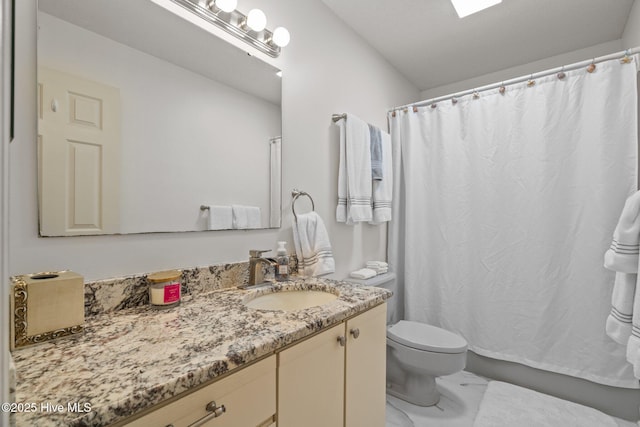 bathroom with vanity, a shower with shower curtain, toilet, and marble finish floor