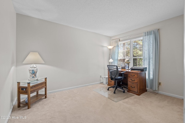 office space featuring light carpet, a textured ceiling, and baseboards