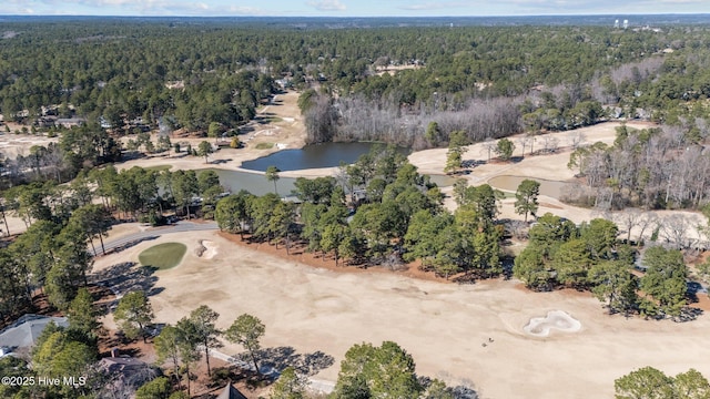 aerial view with a wooded view and a water view