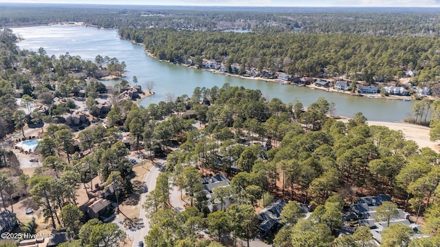 drone / aerial view with a view of trees and a water view