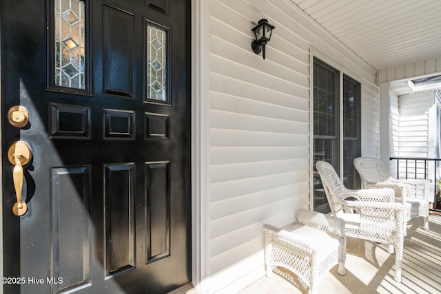 view of exterior entry featuring a porch