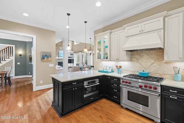 kitchen featuring custom range hood, dark cabinets, white cabinets, and stainless steel appliances