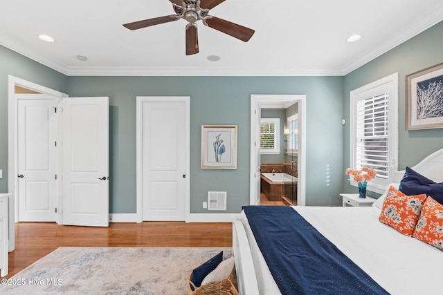 bedroom featuring visible vents, wood finished floors, and ornamental molding