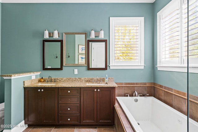 full bathroom with a garden tub, toilet, double vanity, and a sink