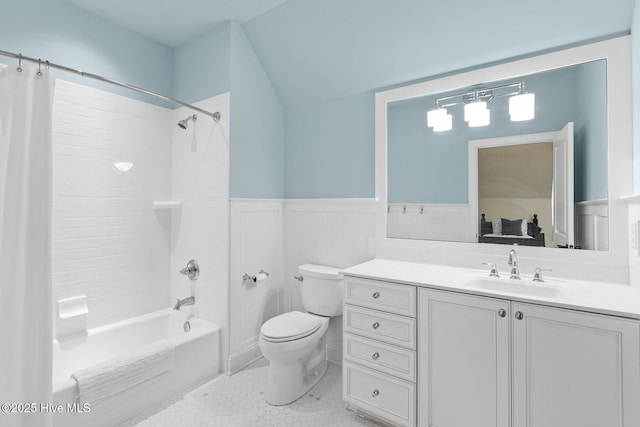 bathroom featuring vanity, lofted ceiling, wainscoting, toilet, and shower / tub combo with curtain