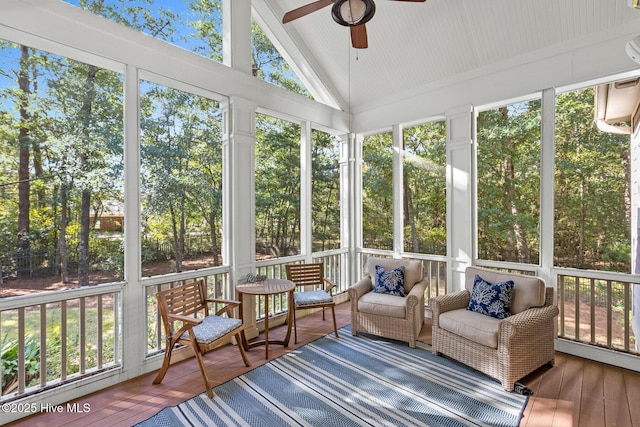 sunroom / solarium featuring lofted ceiling and ceiling fan