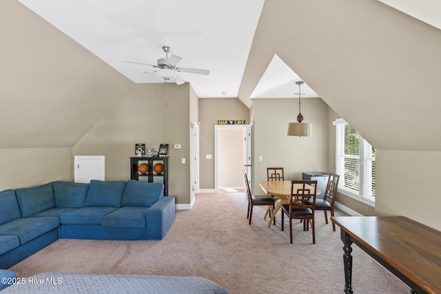 living room featuring a ceiling fan, lofted ceiling, light colored carpet, and baseboards