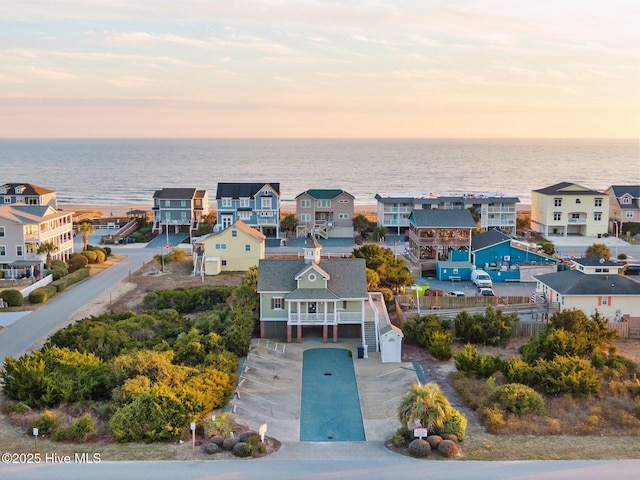 bird's eye view with a residential view and a water view