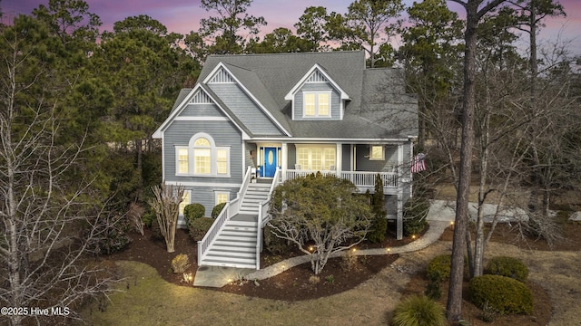 view of front of home with stairway and covered porch