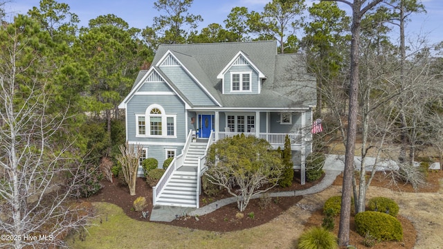 coastal home featuring a porch and stairs