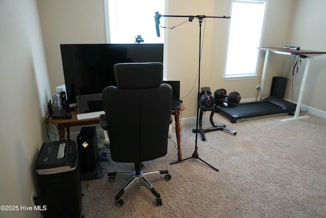 carpeted home office featuring baseboards