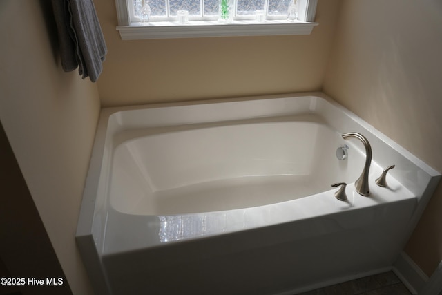 bathroom with a wealth of natural light and a garden tub